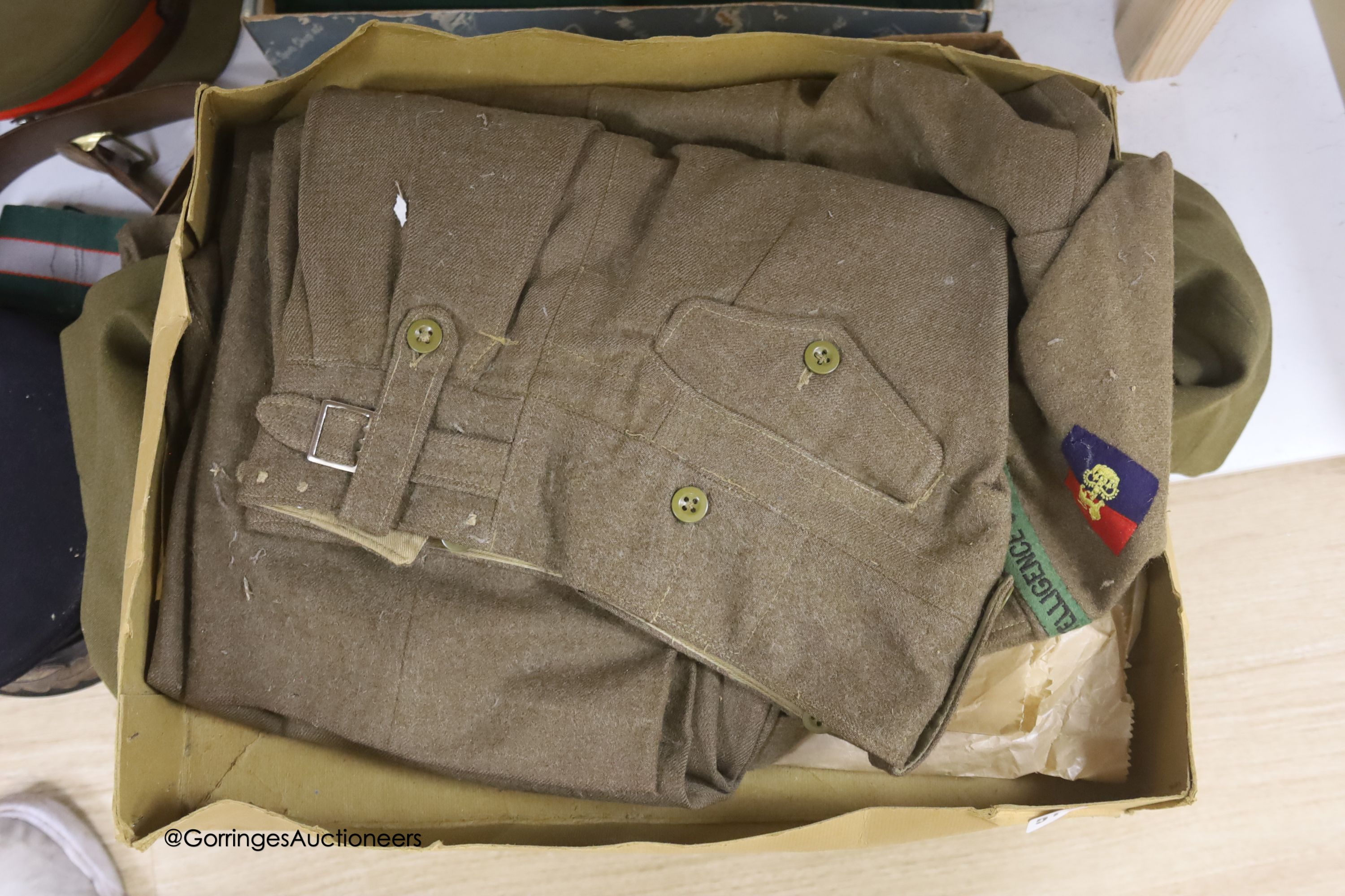 An R.A. cap, dress jacket, pith helmet and SRN uniform
